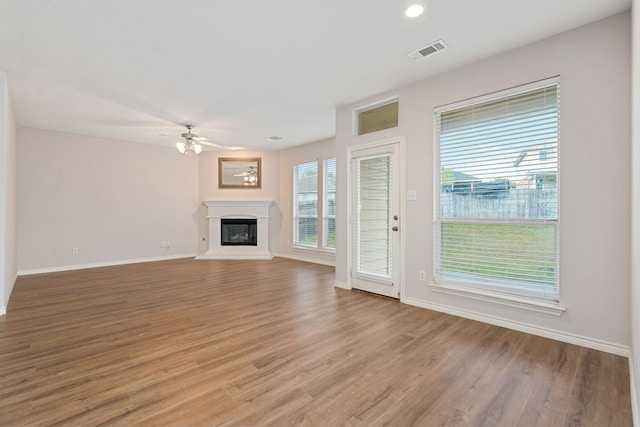 5013 Royal Burgess Dr, Fort Worth, TX 76135 - unfurnished living room featuring light wood finished floors, baseboards, a ceiling fan, and visible vents