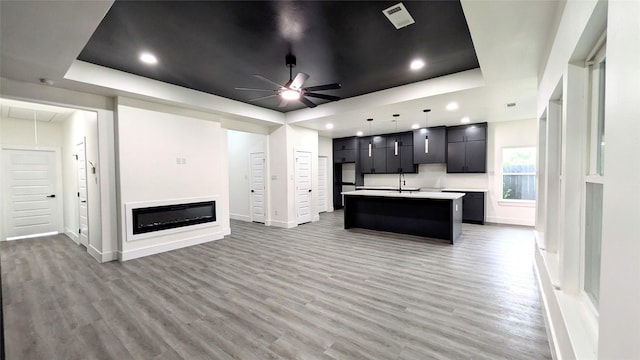 5629 Lester Granger, Fort Worth, TX 76112 - kitchen with a center island with sink, light countertops, light wood-style flooring, a ceiling fan, and recessed lighting