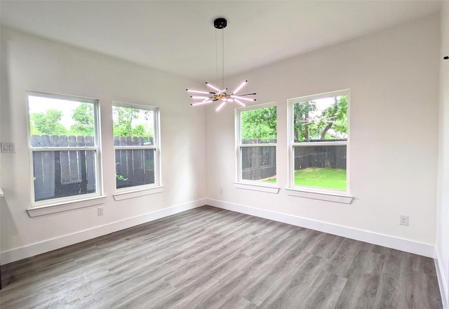 5629 Lester Granger, Fort Worth, TX 76112 - unfurnished room featuring wood finished floors, baseboards, and a chandelier