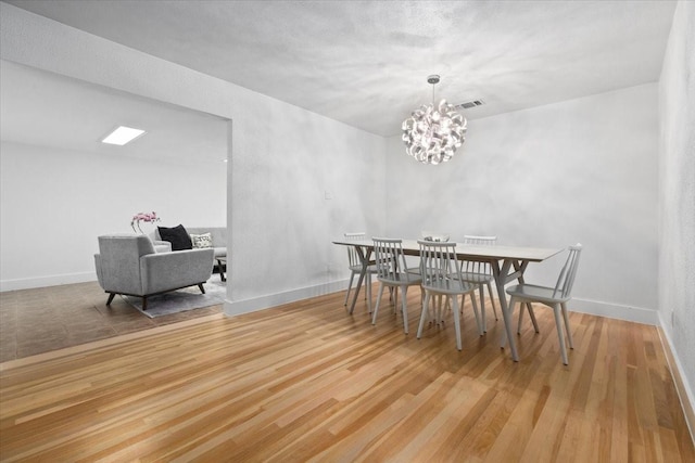 3848 S Drive, Fort Worth, TX 76109 - dining space with light wood finished floors, a chandelier, and baseboards