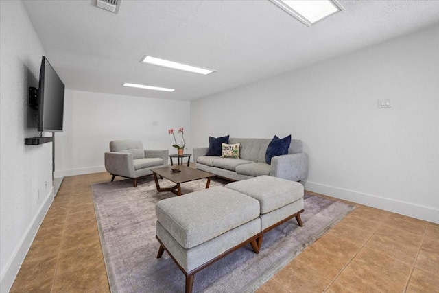 living room featuring tile patterned floors, baseboards, and visible vents