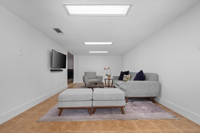 living room with baseboards and visible vents