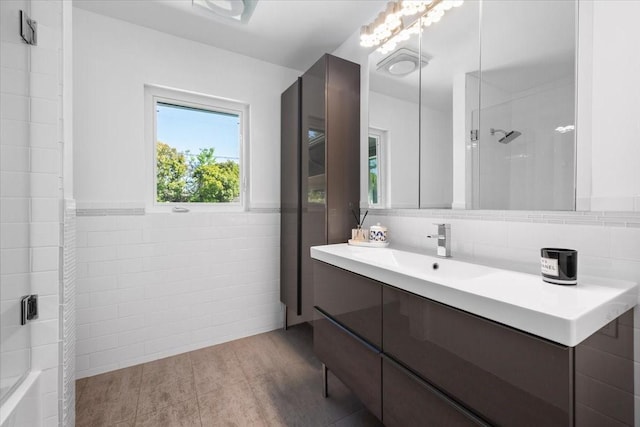 3848 S Drive, Fort Worth, TX 76109 - full bathroom with tile walls, an enclosed shower, vanity, wainscoting, and tile patterned floors