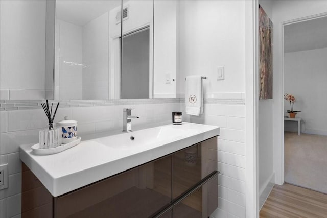 3848 S Drive, Fort Worth, TX 76109 - bathroom with tile walls, vanity, and wood finished floors