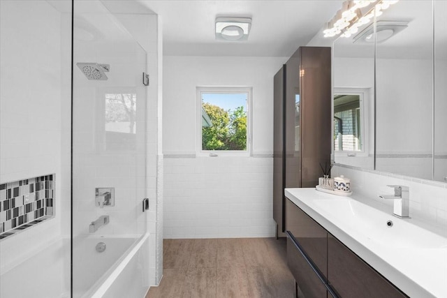 full bathroom with tile walls, shower / bath combination, and vanity