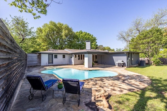 view of pool with central air condition unit, a yard, a fenced backyard, and a patio area