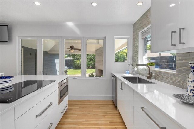 3848 S Drive, Fort Worth, TX 76109 - kitchen featuring a sink, appliances with stainless steel finishes, recessed lighting, light wood-type flooring, and baseboards
