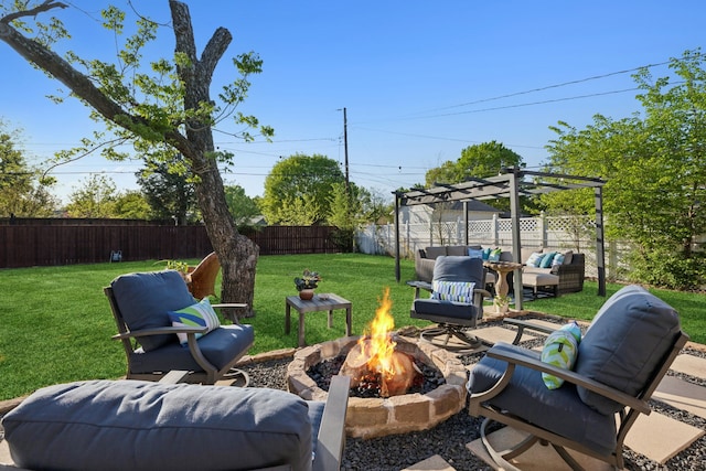 view of yard with an outdoor living space with a fire pit and a fenced backyard