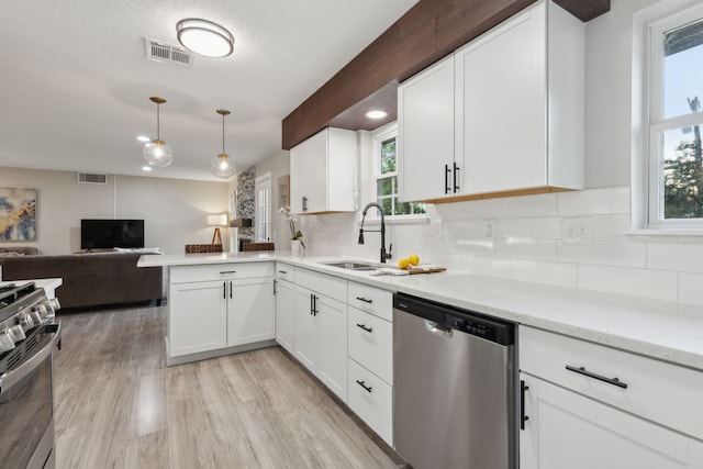 kitchen featuring a sink, visible vents, a wealth of natural light, and stainless steel appliances