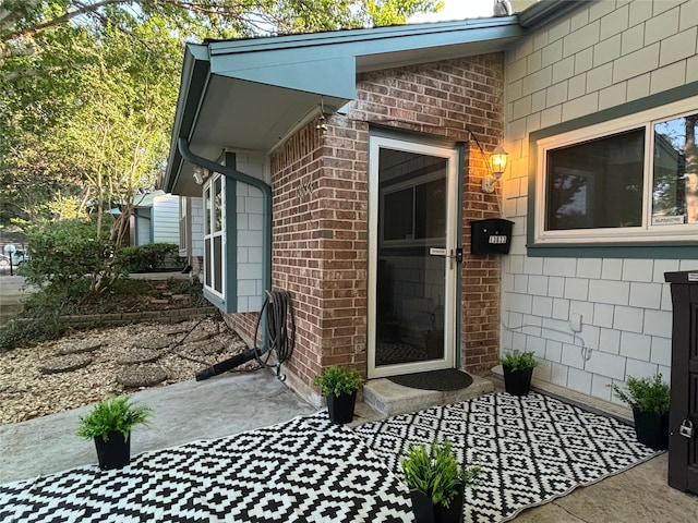 entrance to property with brick siding