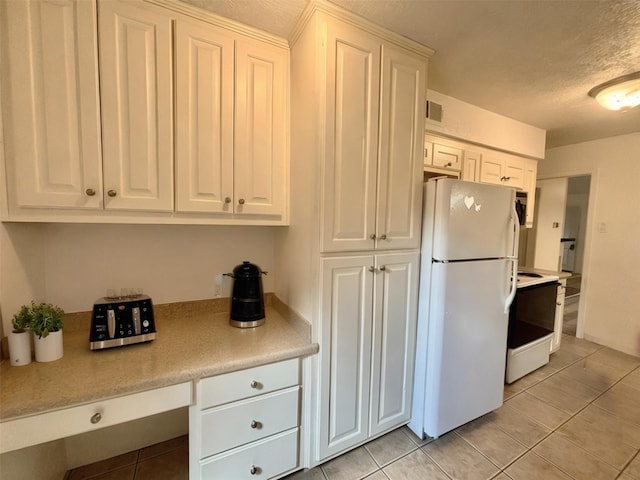 13633 Weald Green St, Dallas, TX 75240 - kitchen featuring white appliances, light tile patterned flooring, light countertops, white cabinets, and a textured ceiling