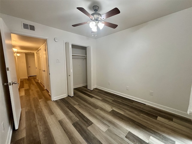 13633 Weald Green St, Dallas, TX 75240 - unfurnished bedroom featuring dark wood-style flooring, baseboards, a closet, and a ceiling fan