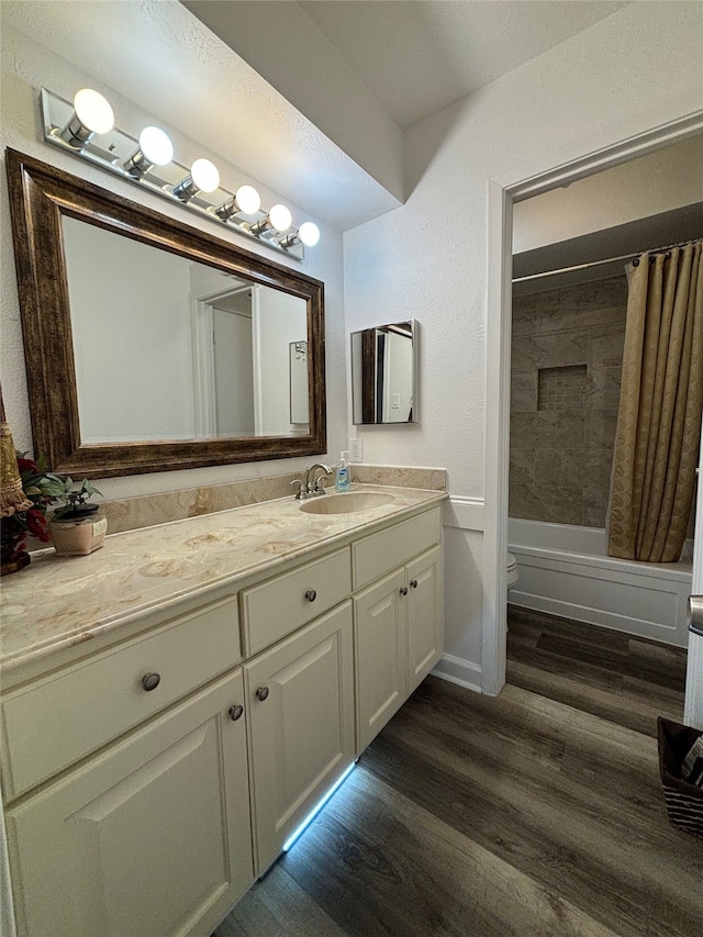 13633 Weald Green St, Dallas, TX 75240 - full bath with vanity, toilet, wood finished floors, shower / bath combo, and baseboards