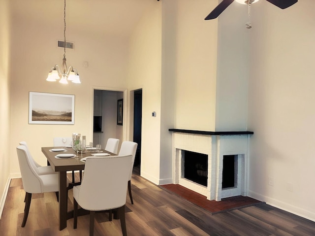 13633 Weald Green St, Dallas, TX 75240 - dining space featuring a brick fireplace, dark wood-type flooring, baseboards, and a high ceiling