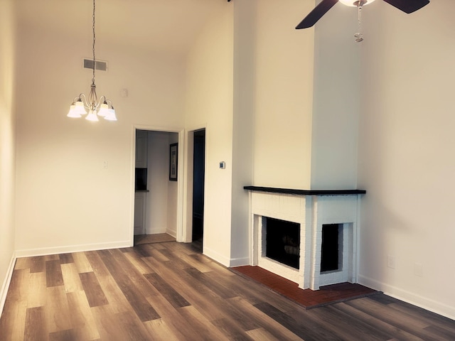 13633 Weald Green St, Dallas, TX 75240 - unfurnished living room featuring a fireplace, dark wood-style floors, a high ceiling, a chandelier, and a ceiling fan