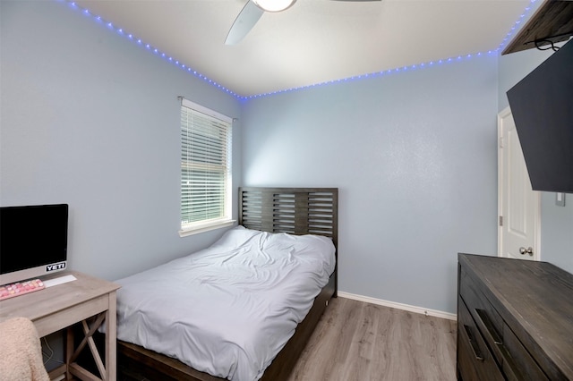 1664 Laramie Ln, Burleson, TX 76028 - bedroom with light wood-style floors, baseboards, and ceiling fan