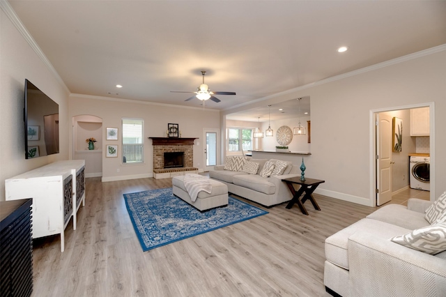 1664 Laramie Ln, Burleson, TX 76028 - living area with washer / clothes dryer, baseboards, ornamental molding, a ceiling fan, and light wood-style floors