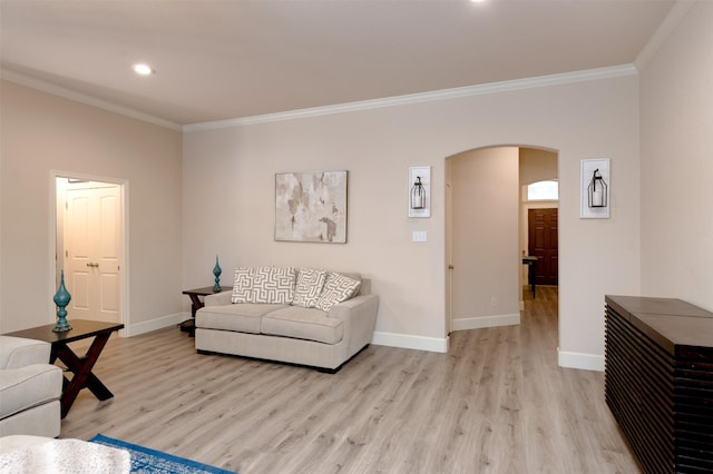 1664 Laramie Ln, Burleson, TX 76028 - living room with ornamental molding, baseboards, light wood finished floors, and arched walkways