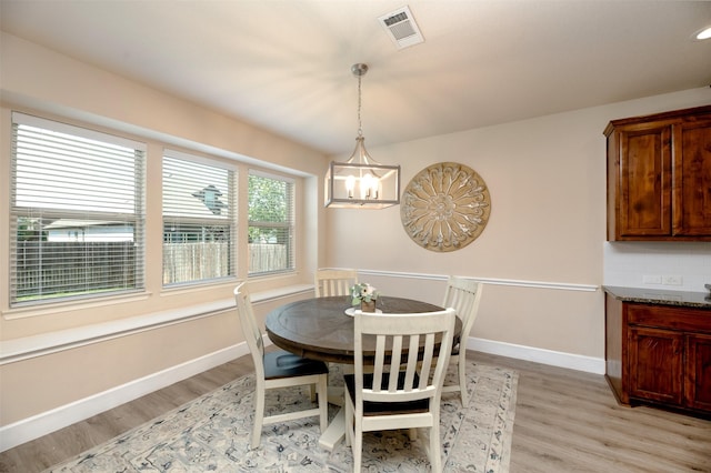 1664 Laramie Ln, Burleson, TX 76028 - dining room with light wood-style flooring, an inviting chandelier, baseboards, and visible vents