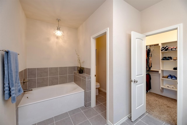 1664 Laramie Ln, Burleson, TX 76028 - full bathroom with a bath, a notable chandelier, toilet, a walk in closet, and tile patterned flooring