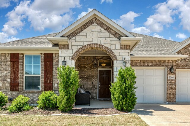 1664 Laramie Ln, Burleson, TX 76028 - view of front facade with brick siding, roof with shingles, driveway, and an attached garage