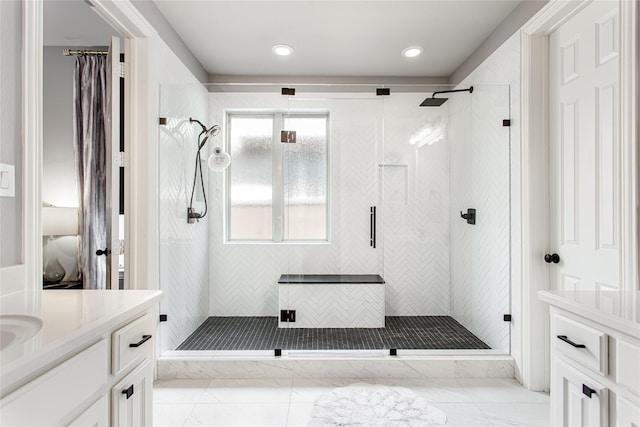 bathroom with recessed lighting, vanity, and a stall shower