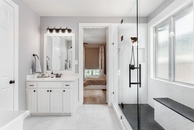 bathroom with vanity, marble finish floor, tiled shower, and ensuite bathroom