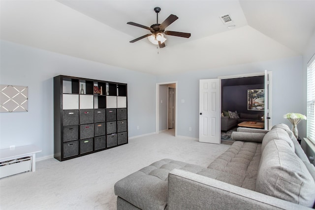 carpeted living area with a baseboard heating unit, baseboards, a ceiling fan, and visible vents