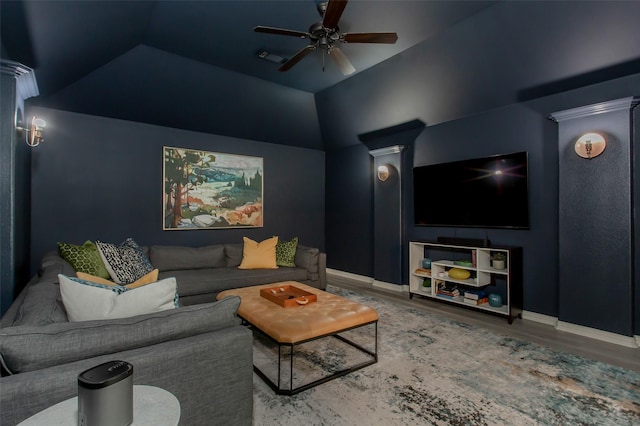 living area with baseboards, vaulted ceiling, wood finished floors, and ceiling fan