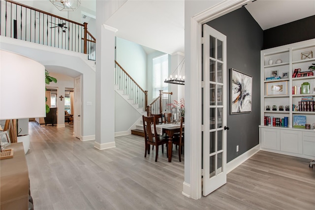 interior space with stairs, wood finished floors, and a chandelier