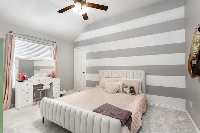 carpeted bedroom featuring vaulted ceiling, baseboards, and a ceiling fan