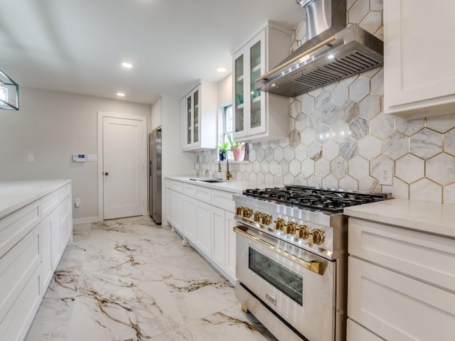 3124 Merrell Rd, Dallas, TX 75229 - kitchen featuring wall chimney exhaust hood, appliances with stainless steel finishes, a sink, recessed lighting, and backsplash