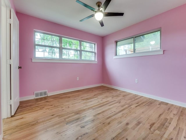 3124 Merrell Rd, Dallas, TX 75229 - spare room featuring light wood finished floors, a ceiling fan, and baseboards