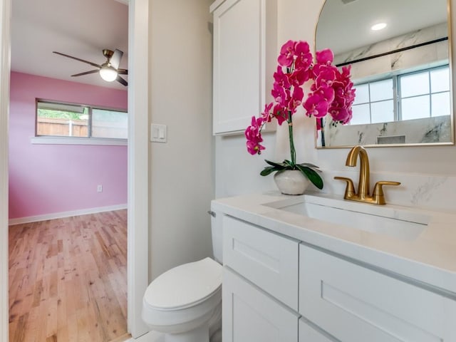 3124 Merrell Rd, Dallas, TX 75229 - bathroom featuring vanity, toilet, wood finished floors, and a ceiling fan