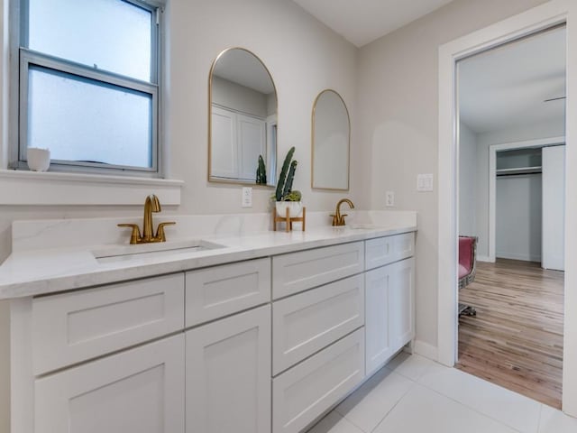 3124 Merrell Rd, Dallas, TX 75229 - full bathroom with double vanity, baseboards, and tile patterned floors