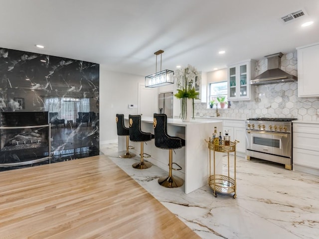 3124 Merrell Rd, Dallas, TX 75229 - bar with wall chimney range hood, stainless steel appliances, backsplash, recessed lighting, and a sink