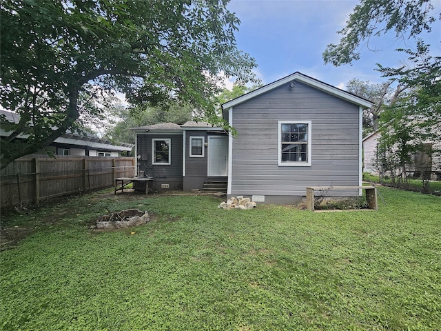 506 E Bowie St, Mexia, TX 76667 - rear view of house featuring entry steps, crawl space, and an outdoor fire pit