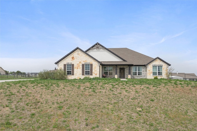 5017 Freestone Dr, Weatherford, TX 76085 - view of front of house featuring fence, a shingled roof, and stone siding
