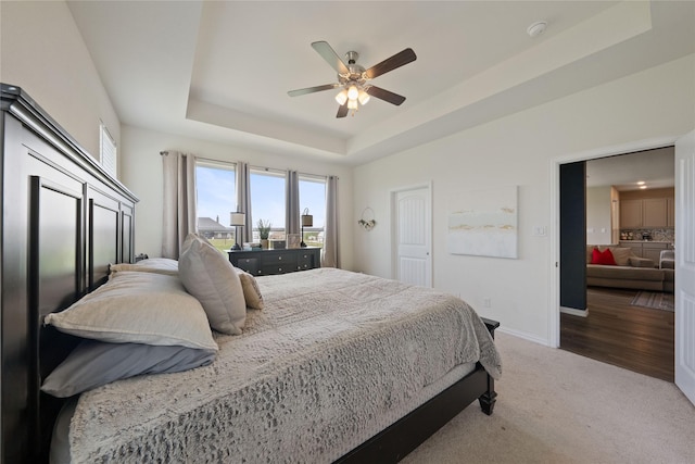 5017 Freestone Dr, Weatherford, TX 76085 - carpeted bedroom with a tray ceiling, baseboards, and ceiling fan
