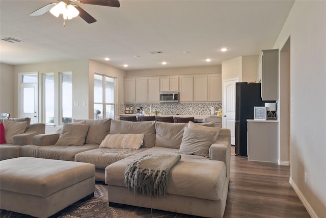 5017 Freestone Dr, Weatherford, TX 76085 - living room featuring dark wood-type flooring, visible vents, a ceiling fan, and baseboards