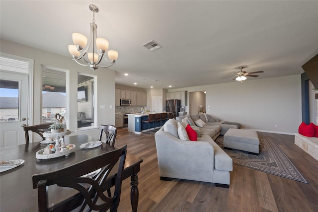 5017 Freestone Dr, Weatherford, TX 76085 - living area featuring recessed lighting, visible vents, dark wood-type flooring, baseboards, and ceiling fan with notable chandelier