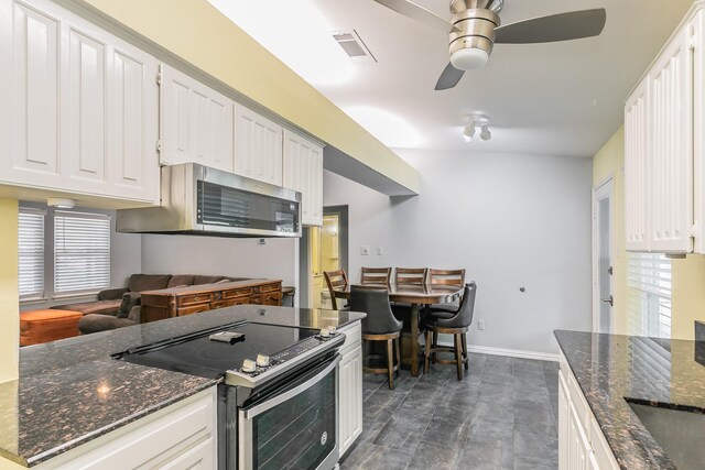 7820 Prairie Dr, Watauga, TX 76148 - kitchen with appliances with stainless steel finishes, ceiling fan, white cabinets, and baseboards