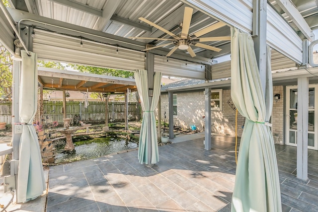 7820 Prairie Dr, Watauga, TX 76148 - view of patio with fence, a small pond, and a ceiling fan