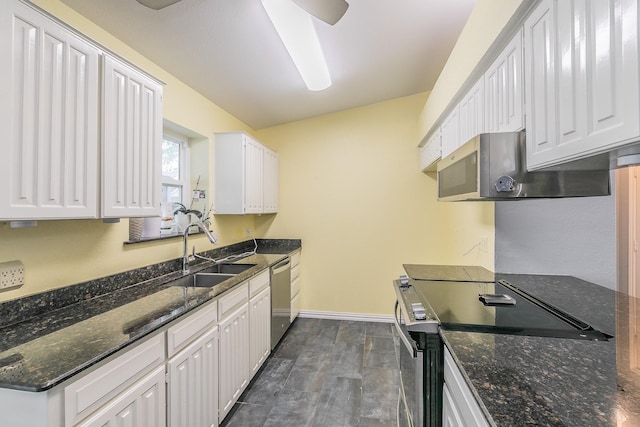 7820 Prairie Dr, Watauga, TX 76148 - kitchen featuring appliances with stainless steel finishes, a sink, white cabinets, baseboards, and vaulted ceiling