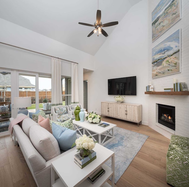 11328 Cider St, Fort Worth, TX 76052 - living area with high vaulted ceiling, wood finished floors, a fireplace, ceiling fan, and baseboards