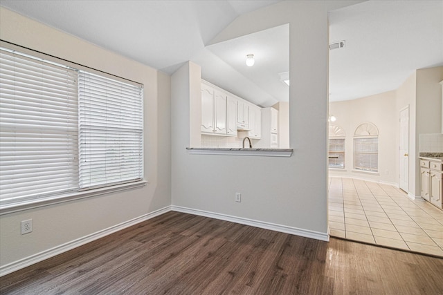 12072 Half Hitch Trl, Frisco, TX 75035 - spare room with visible vents, baseboards, wood finished floors, and lofted ceiling