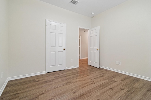12072 Half Hitch Trl, Frisco, TX 75035 - spare room with visible vents, baseboards, and wood finished floors