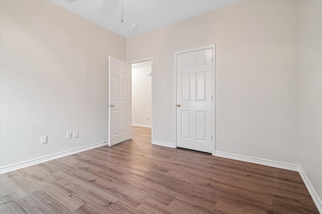 12072 Half Hitch Trl, Frisco, TX 75035 - unfurnished bedroom with wood finished floors and baseboards