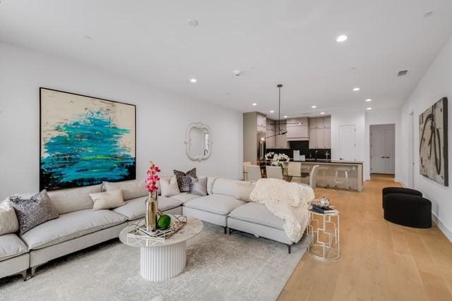 3601 Routh St Unit 1E, Dallas, TX 75219 - living room with recessed lighting and light wood finished floors