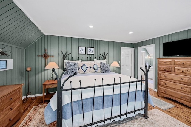 bedroom featuring baseboards, vaulted ceiling, and wood finished floors